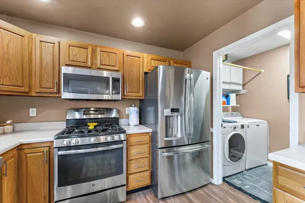 a kitchen with granite countertop a refrigerator stove and microwave