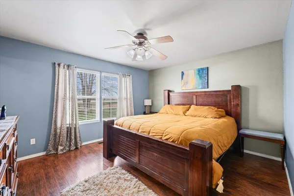 a bedroom with a large bed and a chandelier