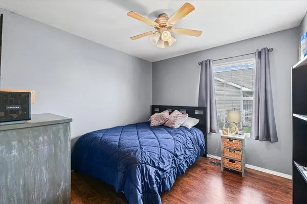 a bedroom with a bed and a chandelier