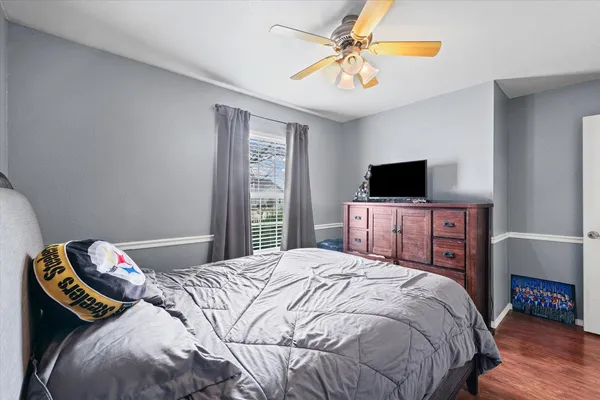 a bedroom with a bed and a tv
