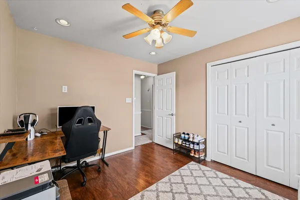 a view of a workspace with furniture and gym equipment
