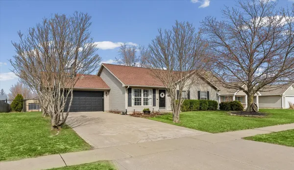 a front view of house with yard and green space