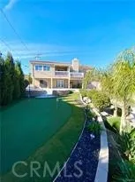 a view of a city with tall buildings and a big yard