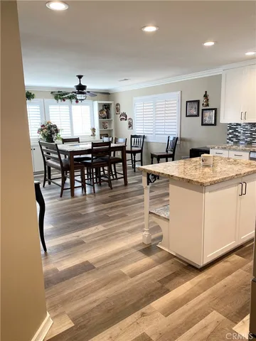 a view of a kitchen with kitchen island and stainless steel appliances