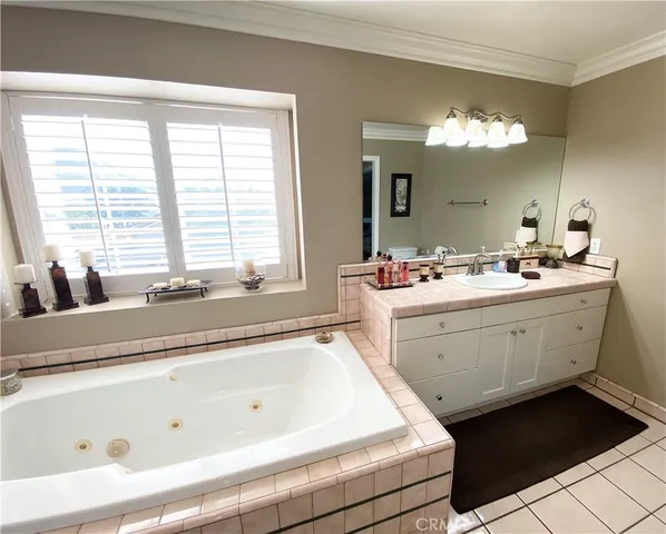a spacious bathroom with a bathtub a sink and a window