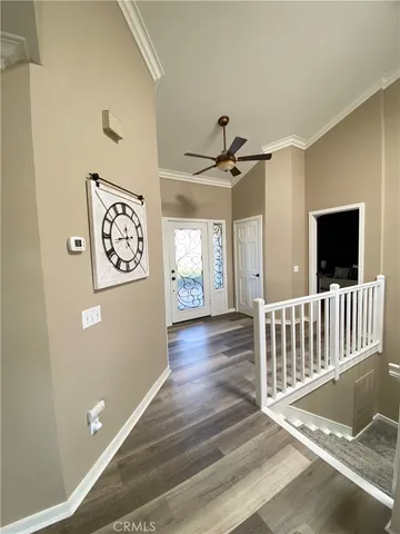 a view of a hallway with wooden floor and windows