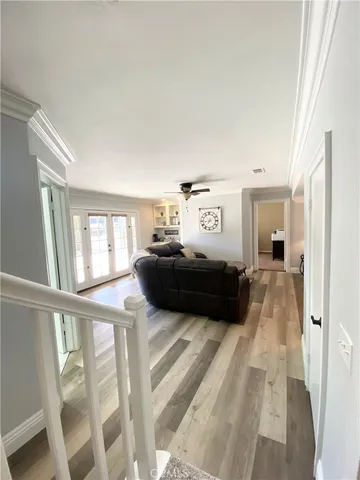 a living room with a bed furniture and a large window