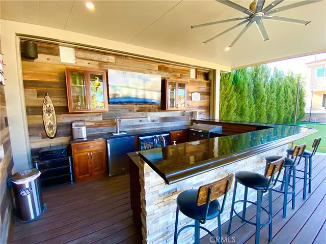 a dining room with furniture a chandelier and wooden floor