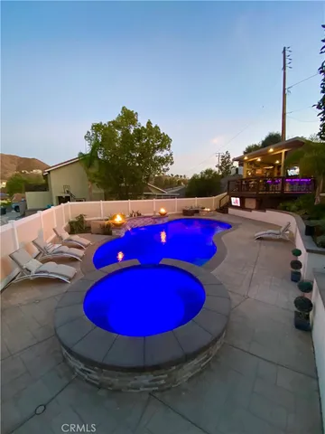 a view of a swimming pool with red chairs