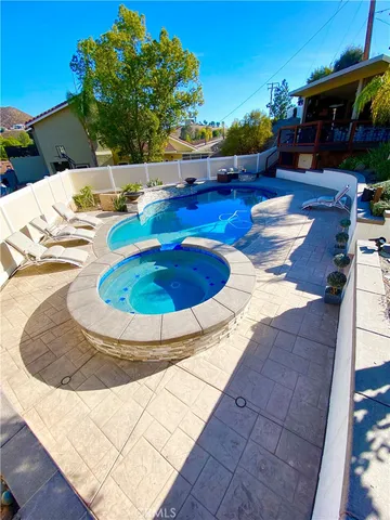 a view of a swimming pool with a yard