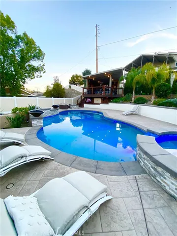a view of a swimming pool with a table and chairs