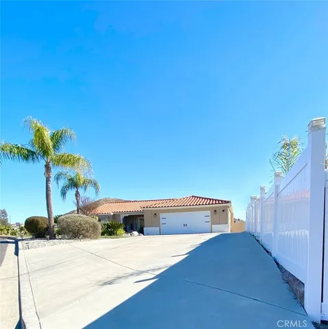 a picture of a house with a yard and potted plants