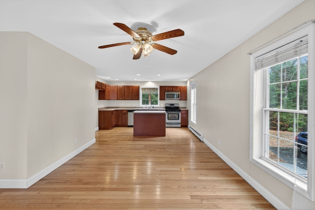 15 Scribner Road Fremont, NH 03044 - Photo 12 of 42 a view of a livingroom with a ceiling fan and wooden floor