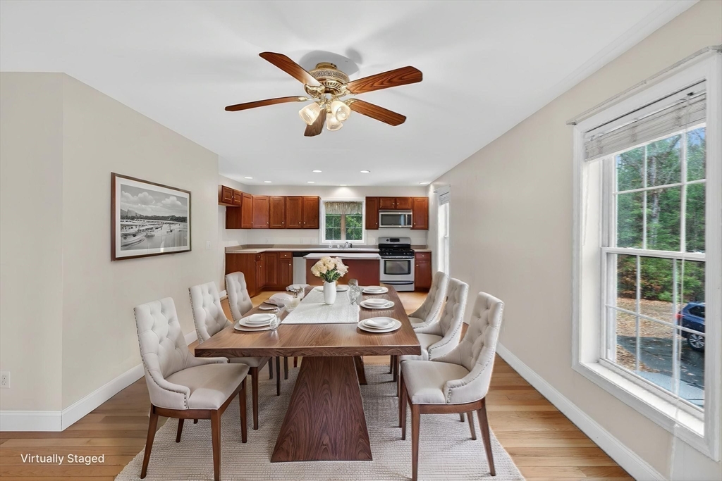 15 Scribner Road Fremont, NH 03044 - Photo 13 of 42 a dining room with furniture a floor to ceiling window and wooden floor