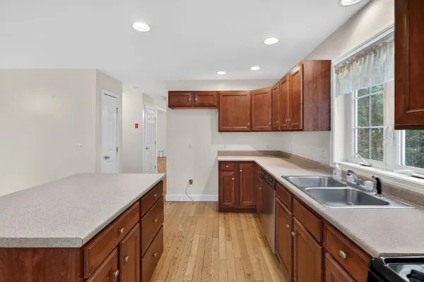 a kitchen with a sink stove and cabinets