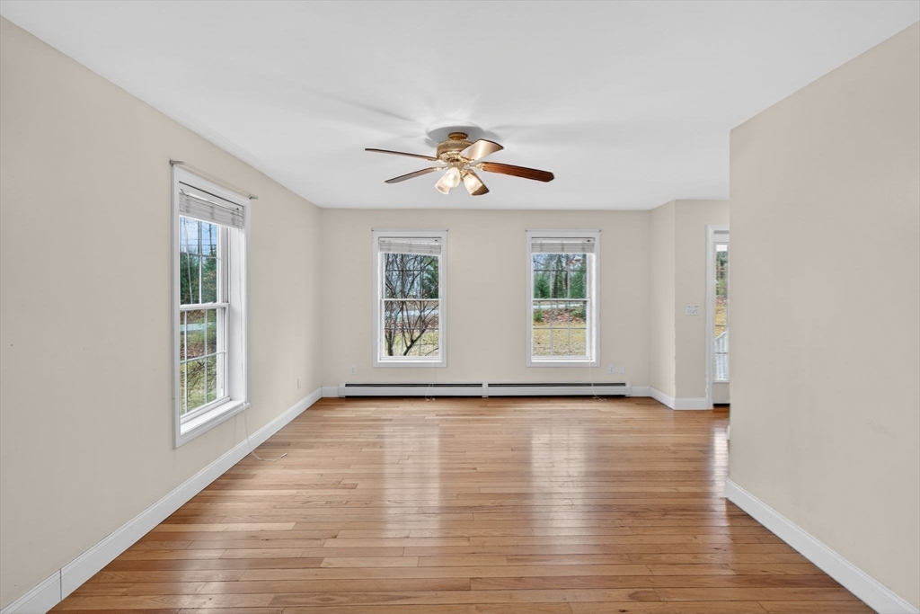 15 Scribner Road Fremont, NH 03044 - Photo 15 of 42 a view of an empty room with a window and wooden floor