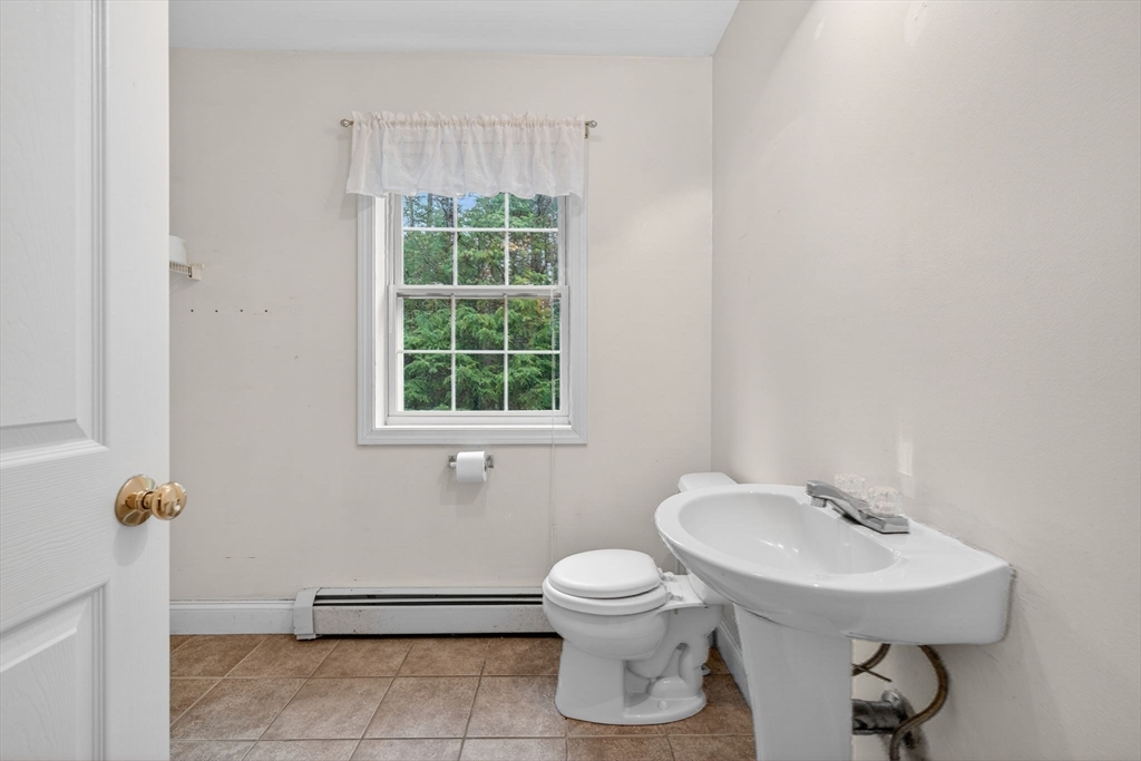 15 Scribner Road Fremont, NH 03044 - Photo 17 of 42 a bathroom with a sink toilet and a mirror