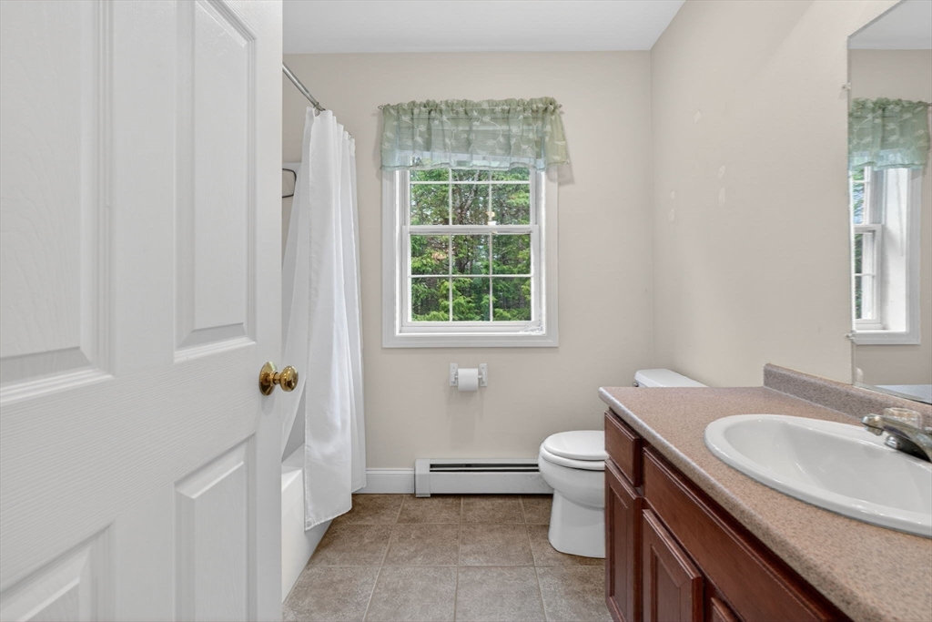 15 Scribner Road Fremont, NH 03044 - Photo 20 of 42 a bathroom with a sink a toilet and tub