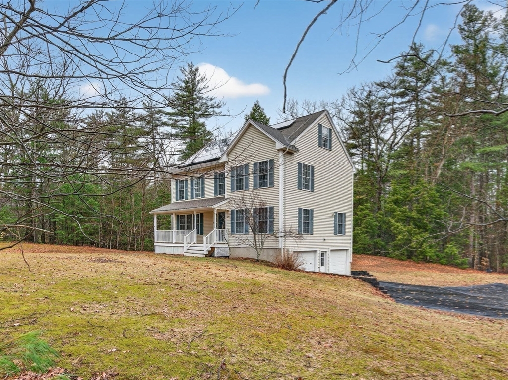 15 Scribner Road Fremont, NH 03044 - Photo 2 of 42 a front view of a house with a yard