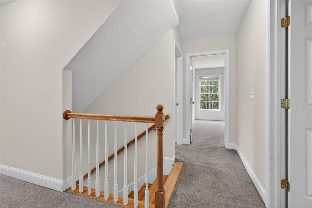 15 Scribner Road Fremont, NH 03044 - Photo 22 of 42 a view of a hallway with wooden floor and stairs