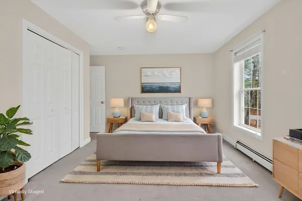 a bedroom with a bed and window