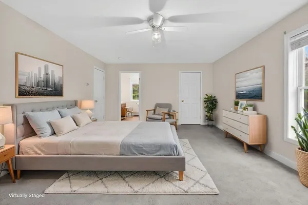 a spacious bedroom with a bed and a couch