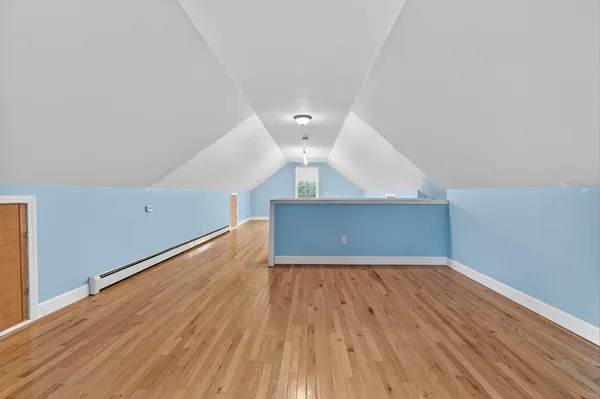 a view of a room with wooden floor