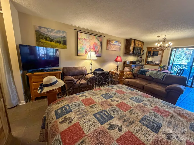 a view of a porch with a floor to ceiling window and yard