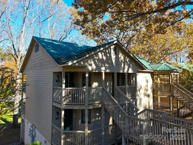 a view of swimming pool with outdoor seating and trees