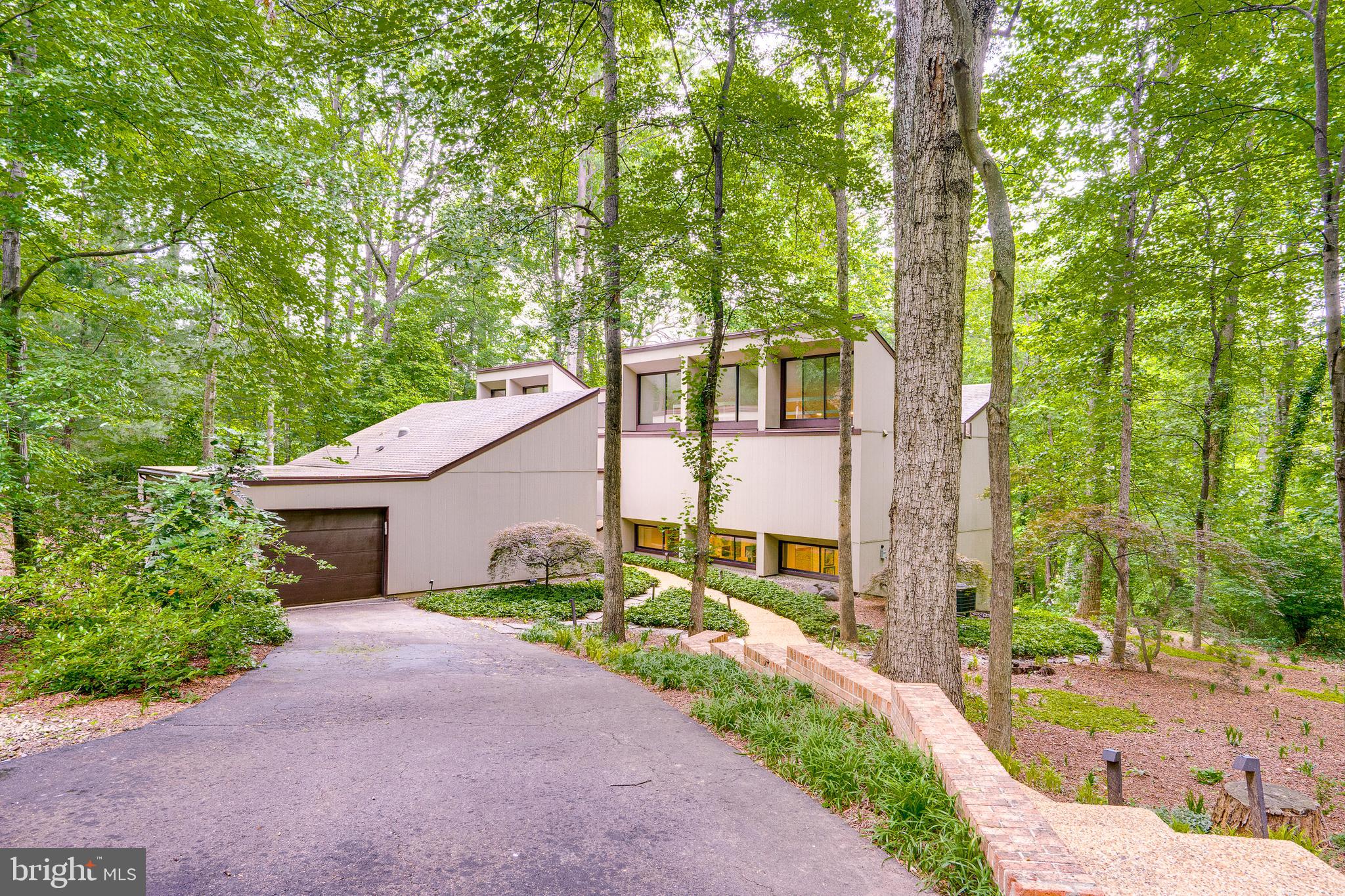11405 Purple Beech Drive Reston, VA 20191 - Photo 1 of 72 a front view of a house with a yard and a garden