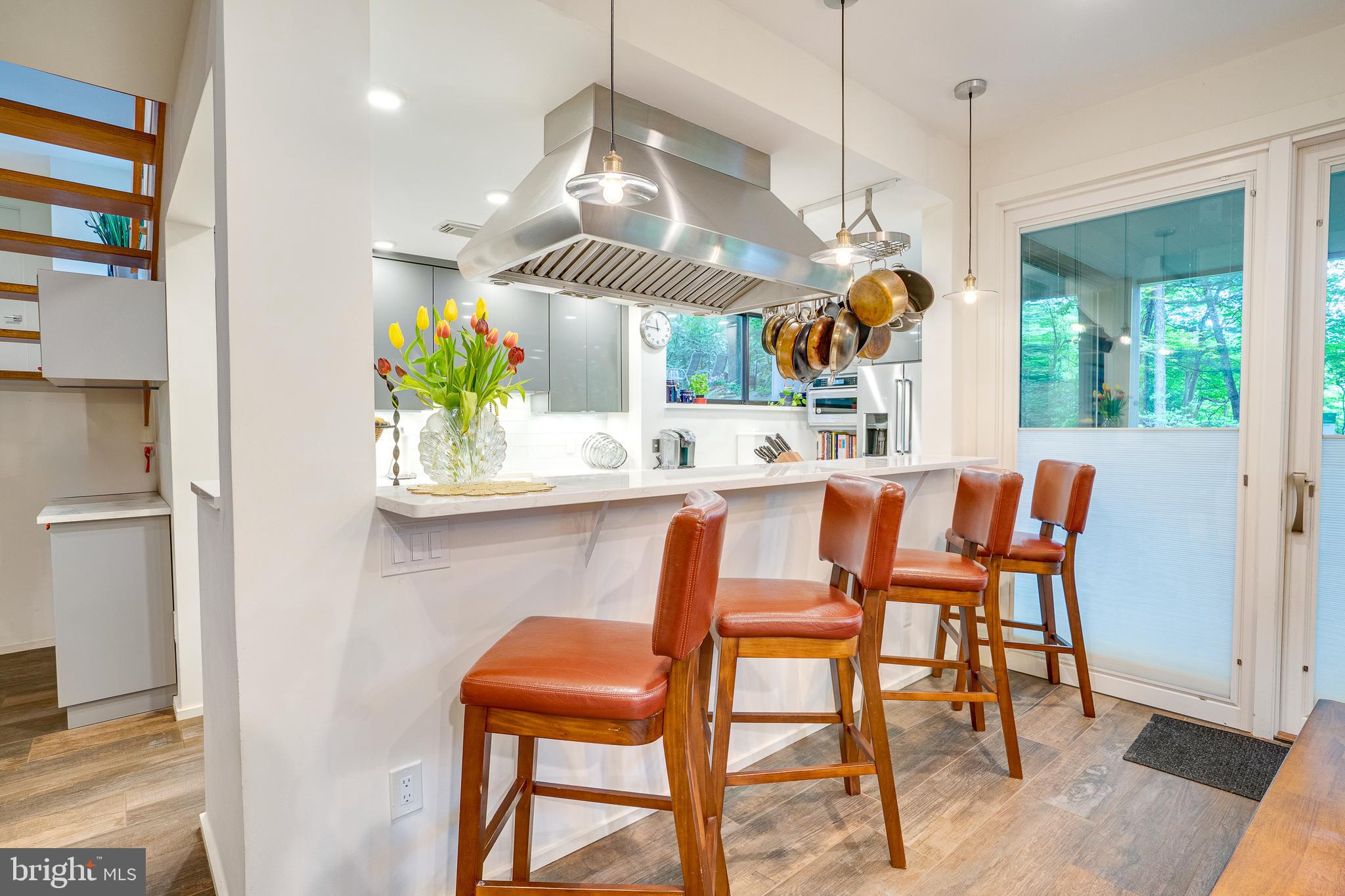 11405 Purple Beech Drive Reston, VA 20191 - Photo 15 of 72 a dining room filled chandelier and wooden floor