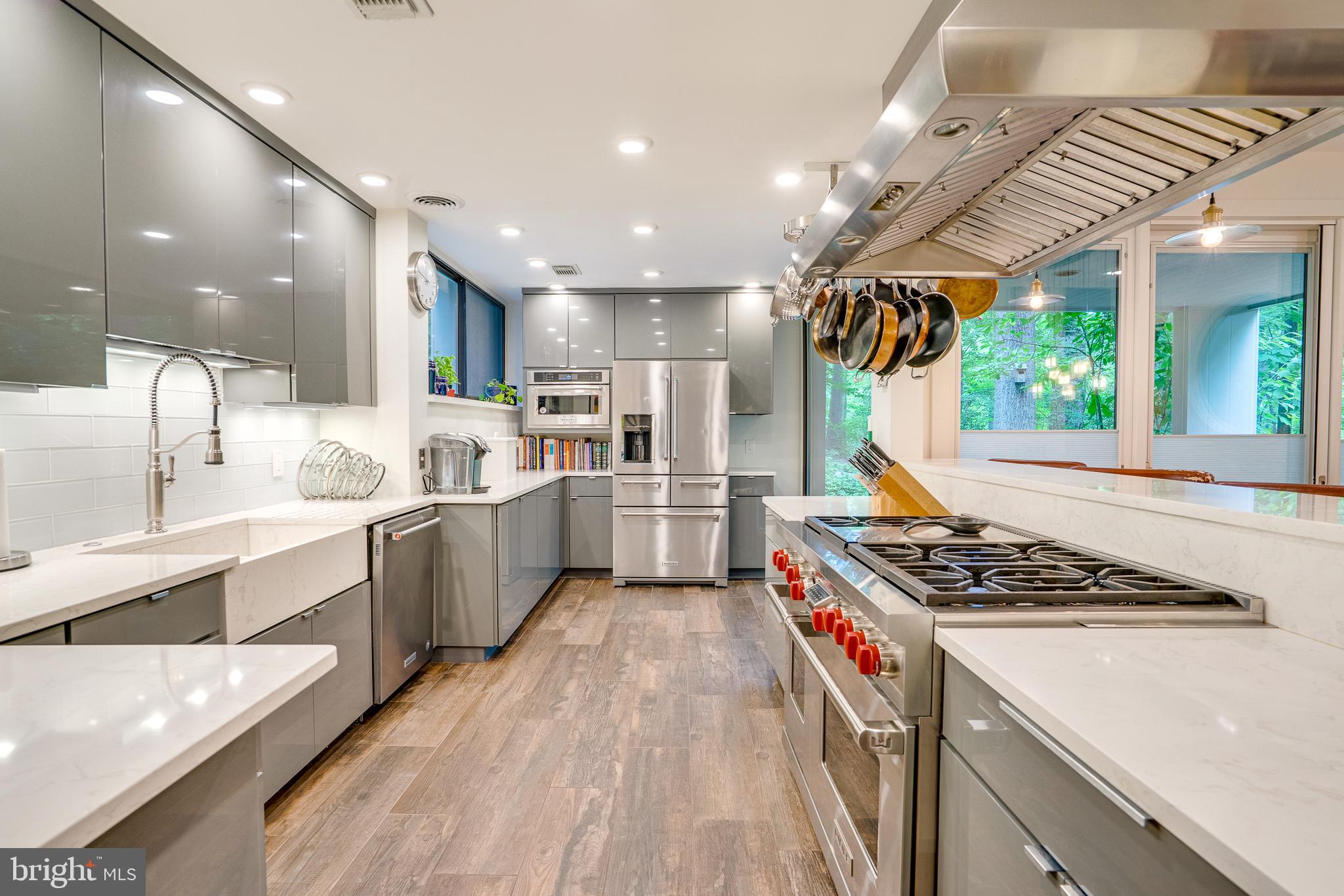 11405 Purple Beech Drive Reston, VA 20191 - Photo 16 of 72 a kitchen with stainless steel appliances granite countertop a stove a sink dishwasher a refrigerator and white cabinets with wooden floor