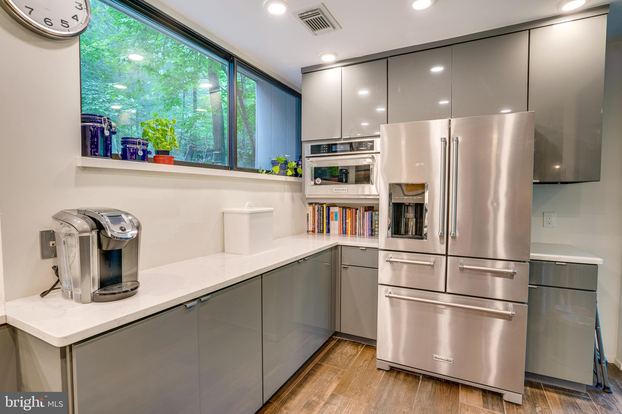 11405 Purple Beech Drive Reston, VA 20191 - Photo 21 of 72 a kitchen with stainless steel appliances a refrigerator a sink and a stove top oven