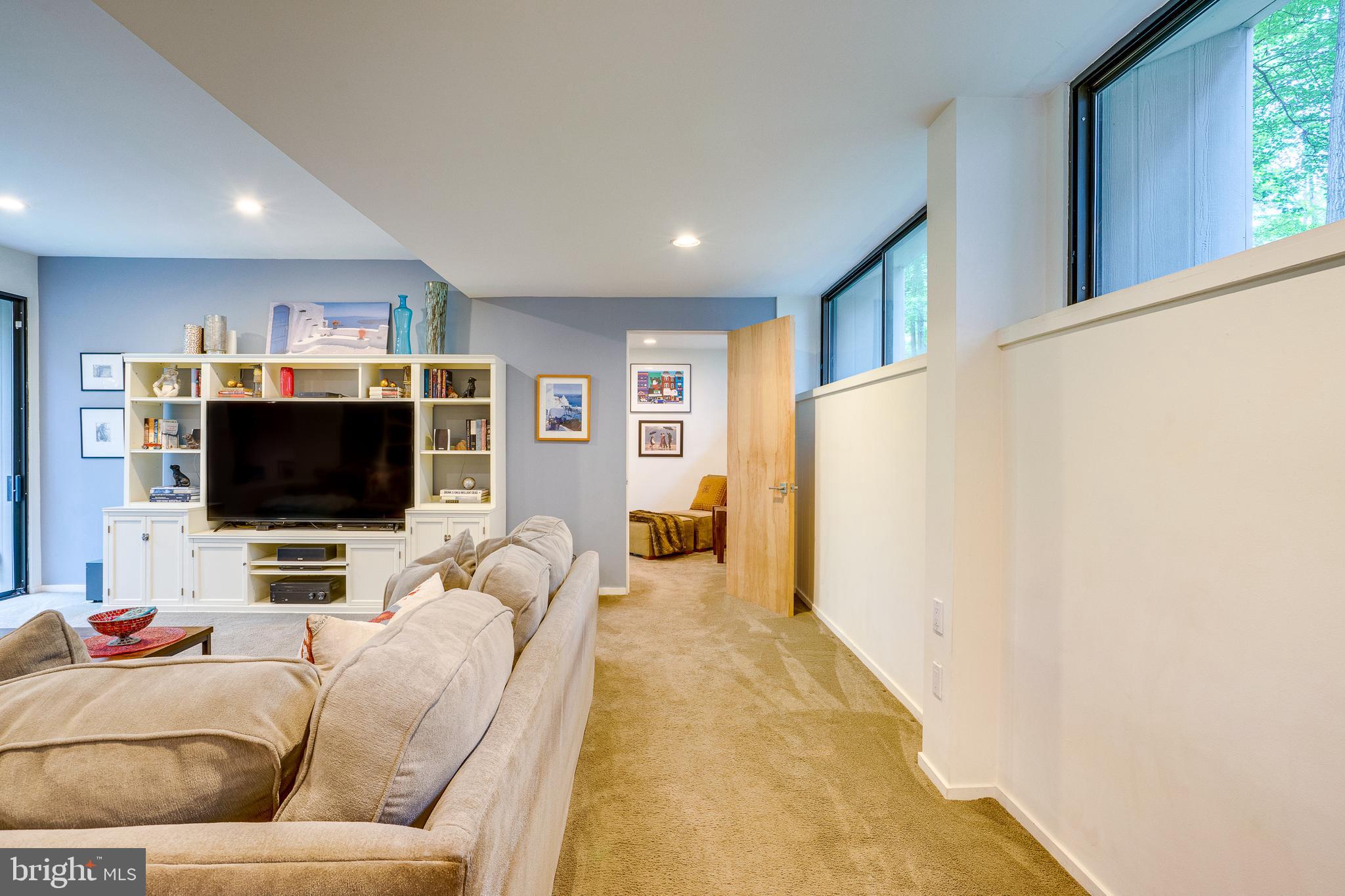 11405 Purple Beech Drive Reston, VA 20191 - Photo 37 of 72 a living room with furniture and a flat screen tv