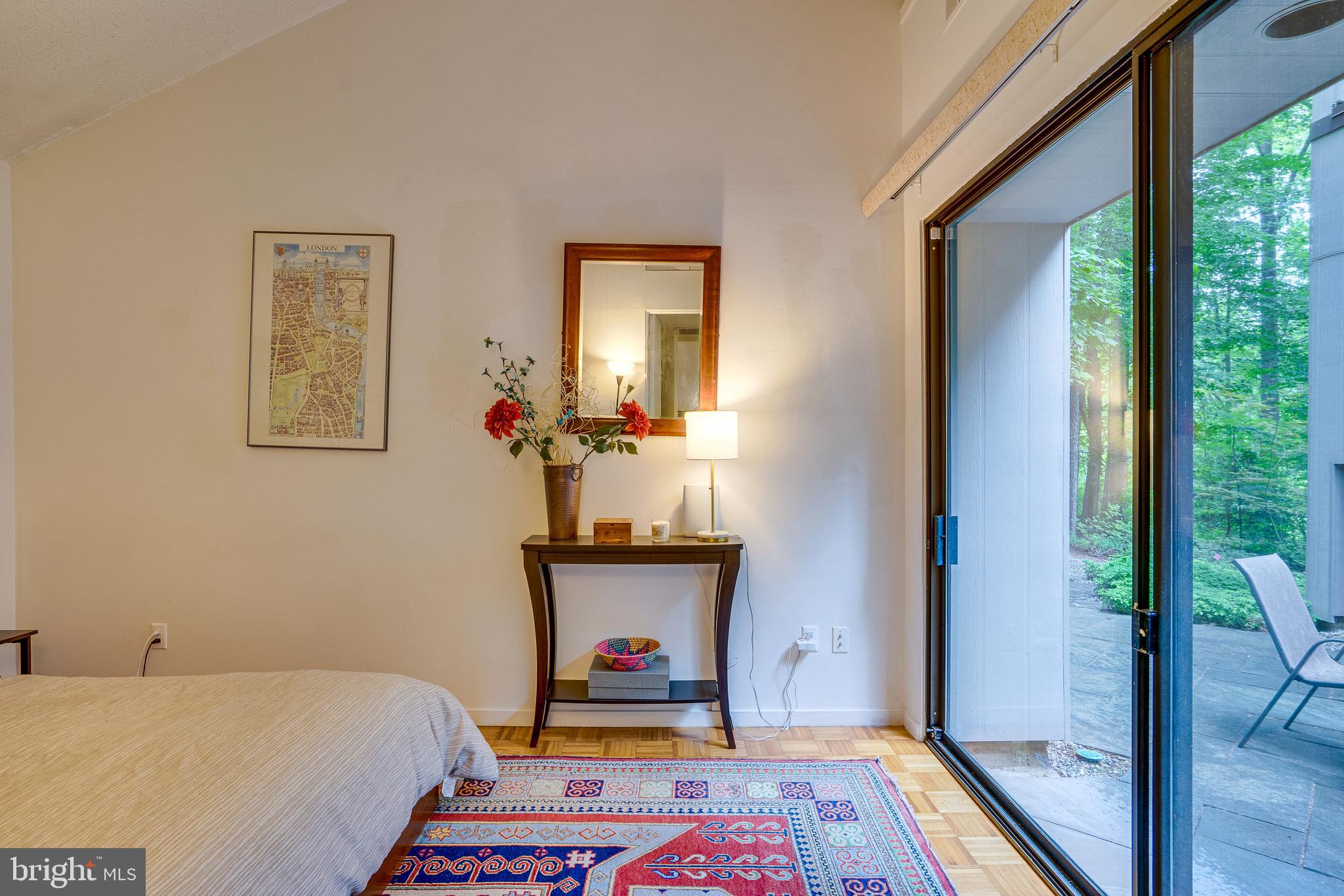 11405 Purple Beech Drive Reston, VA 20191 - Photo 42 of 72 a bedroom with a bed and large windows