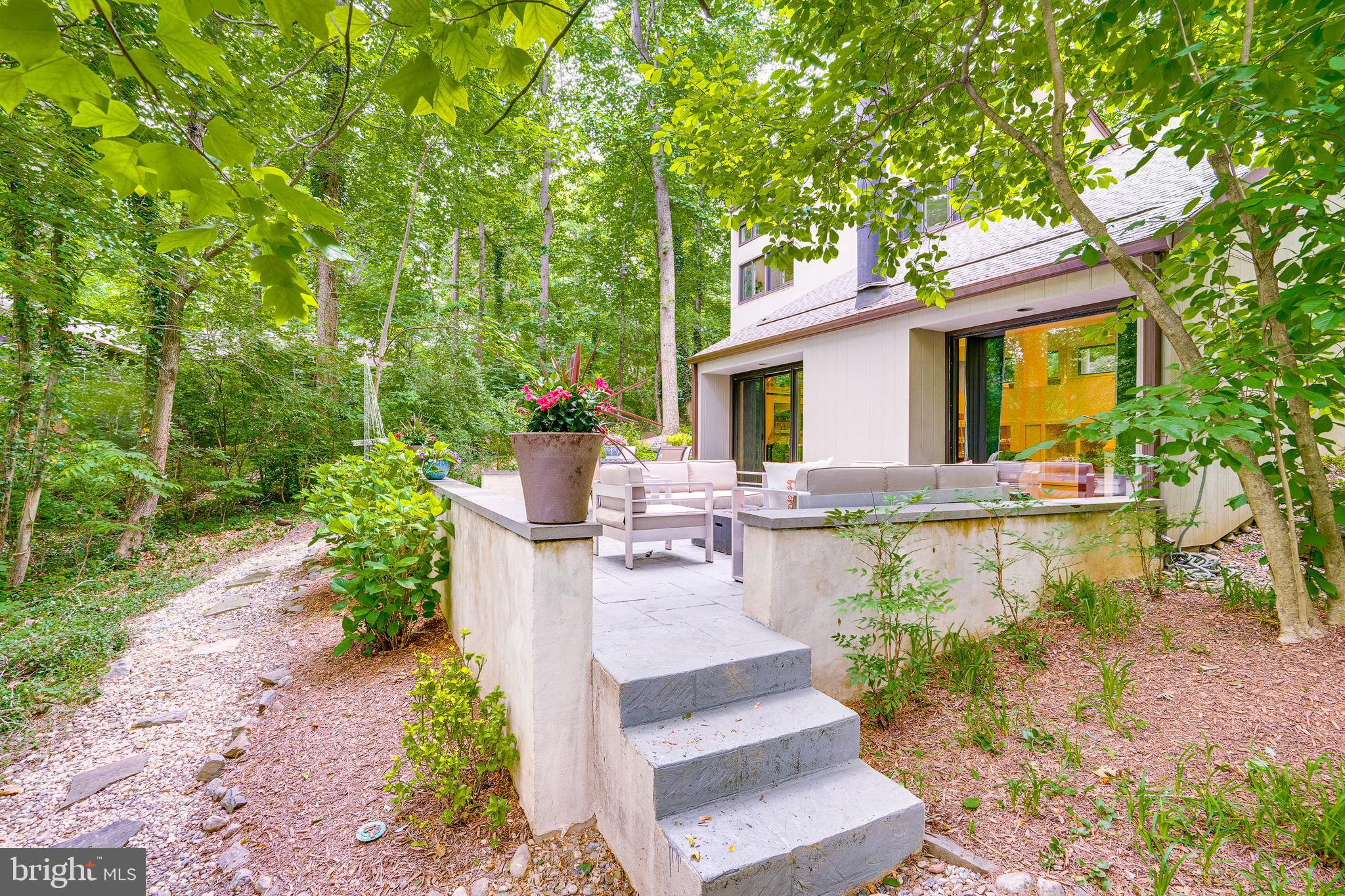 11405 Purple Beech Drive Reston, VA 20191 - Photo 68 of 72 a front view of a house with a garden and sitting area
