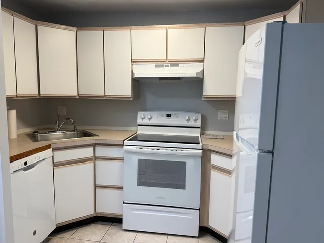 a kitchen with appliances cabinets and a sink