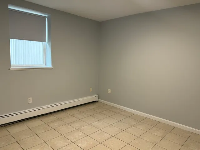 an empty room with wooden floor