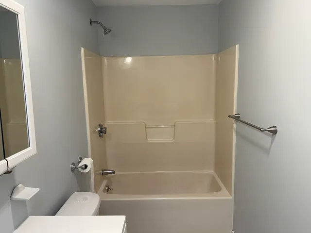 a bathroom with a shower and a toilet