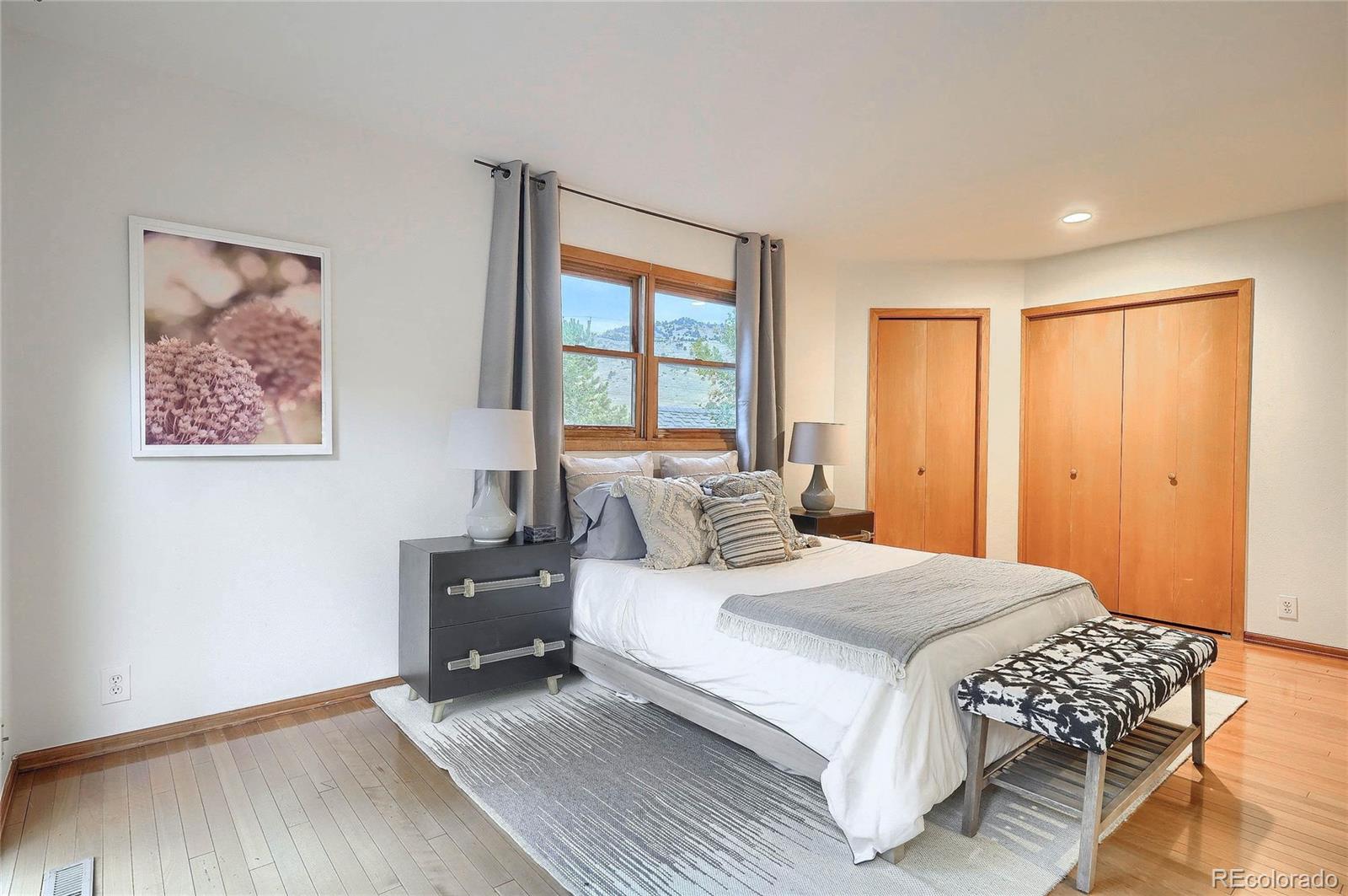 4150 Riverside Avenue Boulder, CO 80304 - Photo 13 of 35 a bedroom with a bed and wooden floor