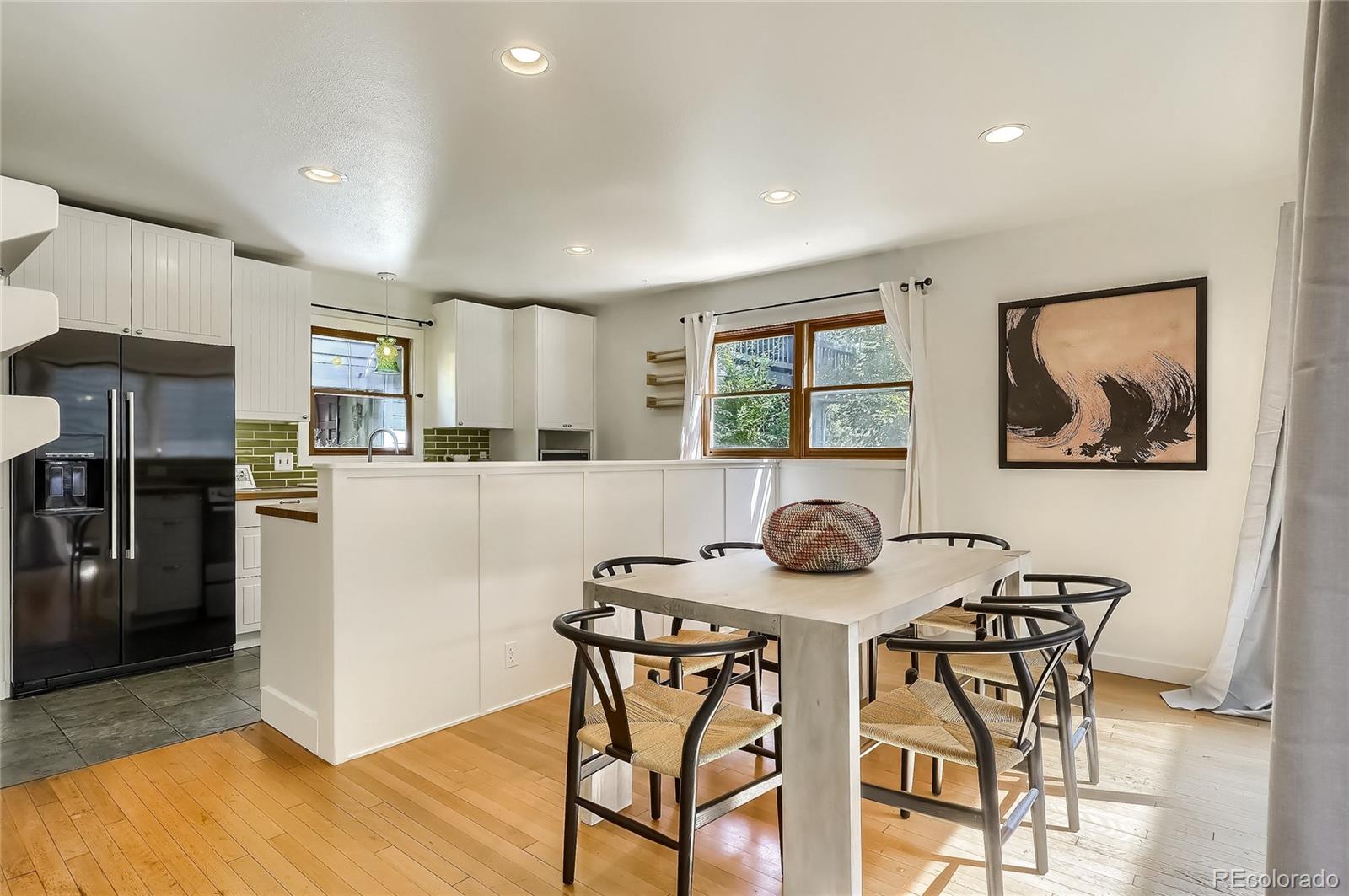 4150 Riverside Avenue Boulder, CO 80304 - Photo 6 of 35 a kitchen with stainless steel appliances kitchen island granite countertop a table and chairs in it