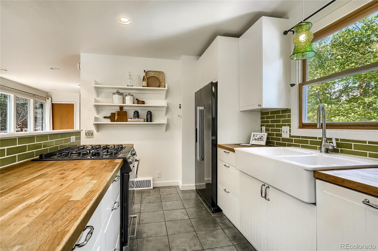 4150 Riverside Avenue Boulder, CO 80304 - Photo 9 of 35 a kitchen with stainless steel appliances granite countertop a sink and a refrigerator