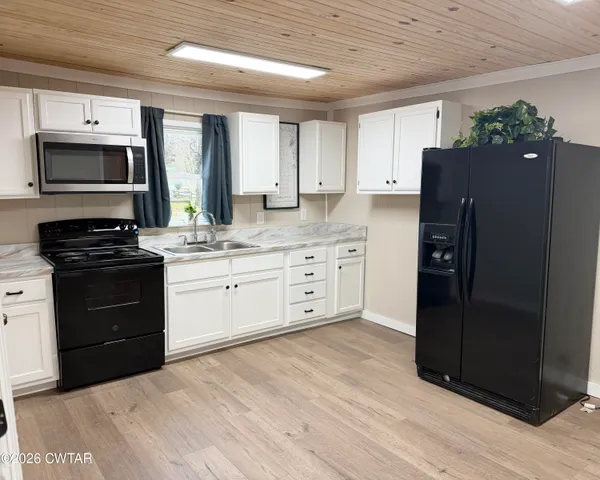 a kitchen with stainless steel appliances granite countertop a refrigerator and a stove