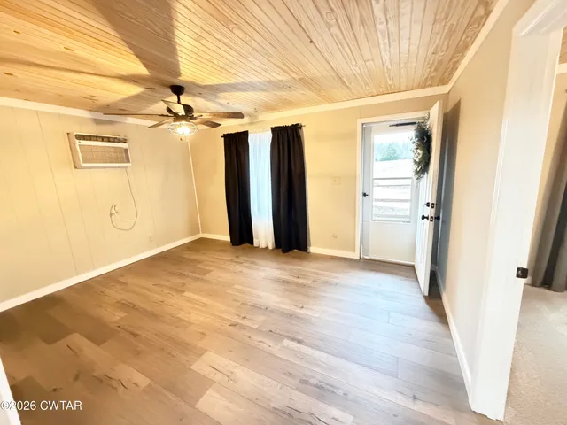 en empty room with an entryway and chandelier