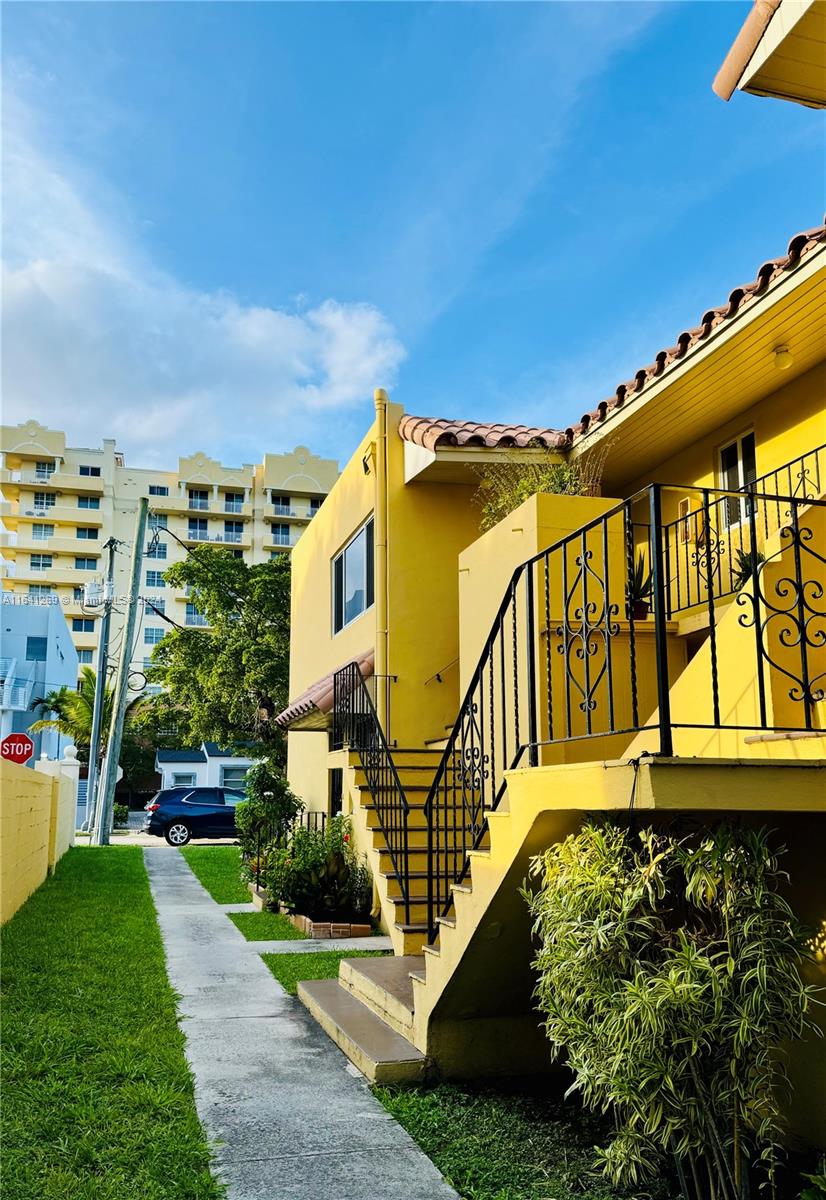 4080 Southwest 2nd Terrace, Unit 2 Miami, FL 33134 - Photo 6 of 19 a view of a swimming pool with a garden and plants