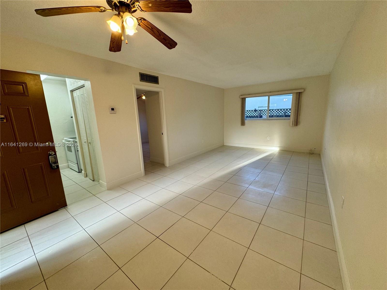 4080 Southwest 2nd Terrace, Unit 2 Miami, FL 33134 - Photo 8 of 19 wooden floor in an empty room with a window
