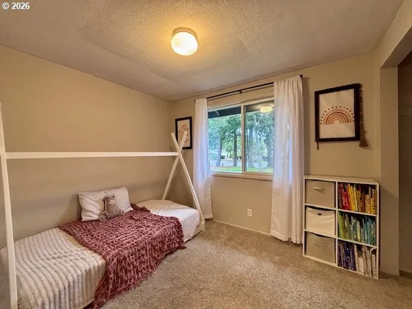 a bedroom with a bed and a book shelf