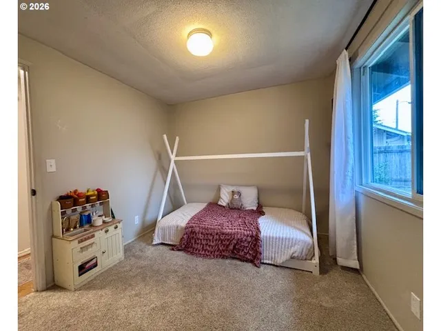 a bedroom with a bed and cabinets