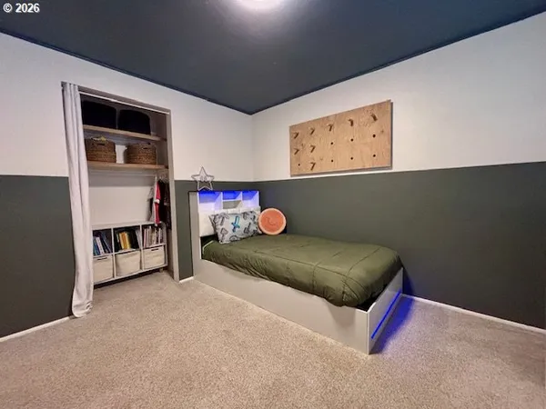 a bedroom with a bed and a dresser