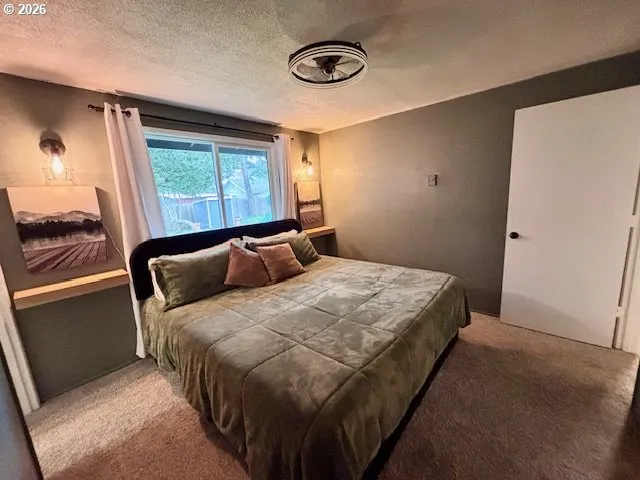 a bedroom with a bed and a mirror